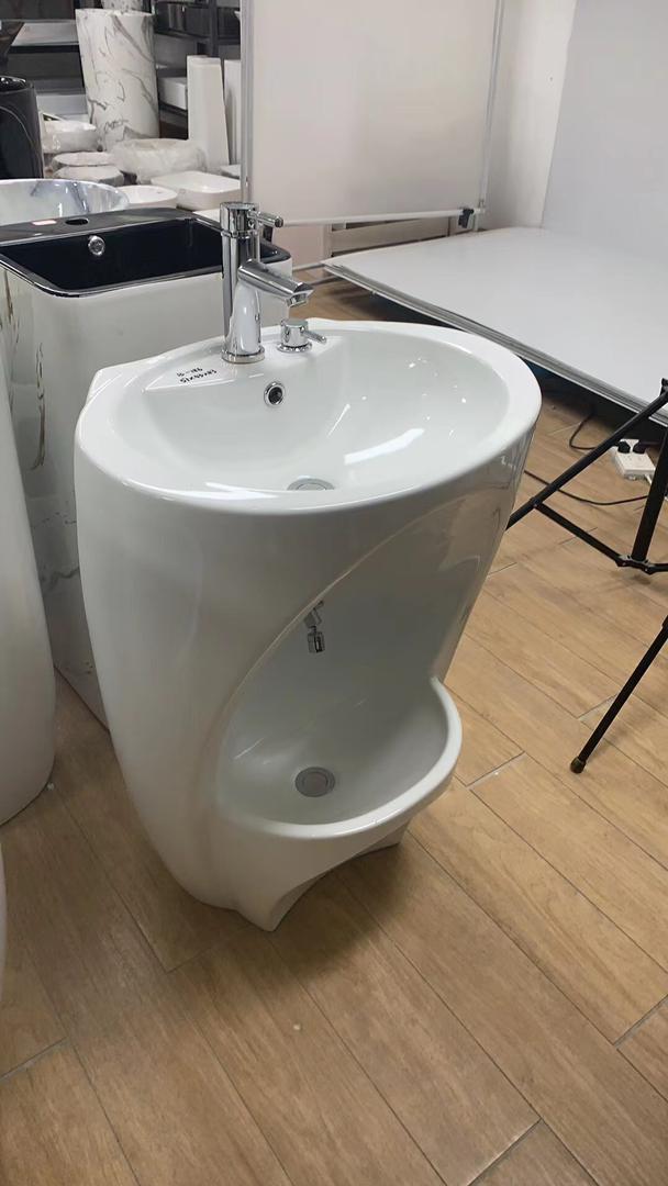 White Wudu Basin in a shop setting with other products in the background. 